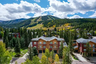 an aerial view of a resort with mountains in the background at Riverside Retreat condo in Winter Park