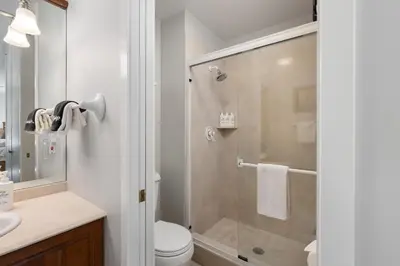 a bathroom with a shower and a toilet and a sink at Riverside Retreat condo in Winter Park