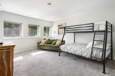 a bedroom with a bunk bed and a couch at Riverside Retreat condo in Winter Park