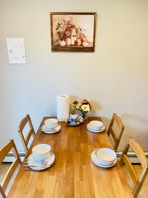 a dining room table with chairs and a painting on the wall at Getaway Spot Close To Red Rocks, Denver & Mtns in Lakewood