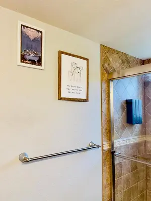 a bathroom with a shower with two pictures on the wall at Getaway Spot Close To Red Rocks, Denver & Mtns in Lakewood
