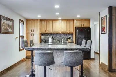 a kitchen with a large island with bar stools at Grand Family Home with Deck and Trail Access in Fraser in Fraser
