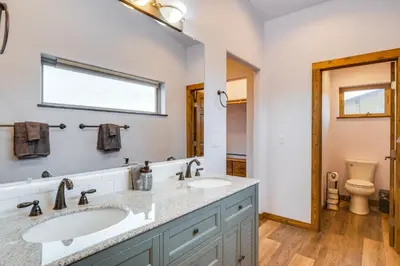 a bathroom with a sink and a toilet at Grand Family Home with Deck and Trail Access in Fraser in Fraser