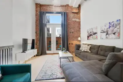a living room with a couch and a tv at Loft Retreat - King Bed&Balcony - Pet-Friendly 30 in Denver