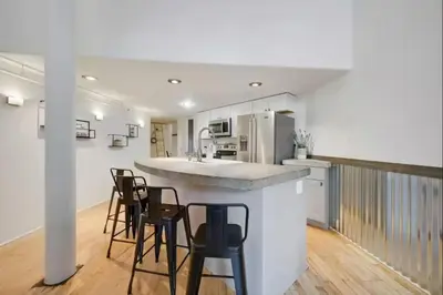 a kitchen with a counter and stools in a room at Loft Retreat - King Bed&Balcony - Pet-Friendly 30 in Denver