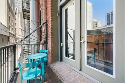 a balcony with blue chairs and a table at Loft Retreat - King Bed&Balcony - Pet-Friendly 30 in Denver