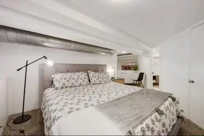 a white bedroom with a large bed and a desk at Loft Retreat - King Bed&Balcony - Pet-Friendly 30 in Denver