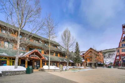 a town square with buildings and trees and snow at Arapahoe Lodge-1BR and Murphy Condo -Kids Ski Free condo in Keystone