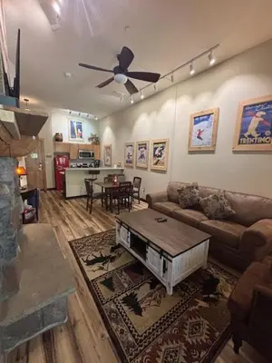 a living room with a couch and a table at Arapahoe Lodge-1BR and Murphy Condo -Kids Ski Free condo in Keystone