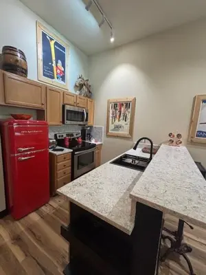 a kitchen with a red refrigerator and a counter top at Arapahoe Lodge-1BR and Murphy Condo -Kids Ski Free condo in Keystone