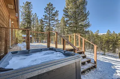 a jacuzzi tub on the deck of a house at Cozy Wolfcamp Chalet with Hot Tub, Views with Fast Wifi in Bailey