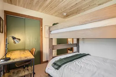 a bedroom with a bunk bed and a desk at Cozy Wolfcamp Chalet with Hot Tub, Views with Fast Wifi in Bailey