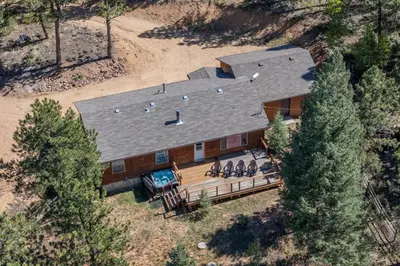 an overhead view of a house with people sitting on a deck at Cozy Wolfcamp Chalet with Hot Tub, Views with Fast Wifi in Bailey