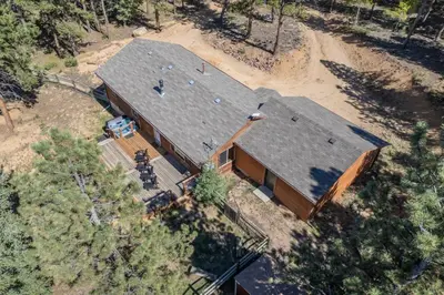 an overhead view of a large house in the woods at Cozy Wolfcamp Chalet with Hot Tub, Views with Fast Wifi in Bailey