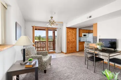 a living room with a table and a chair at St Marys Glacier Getaway in Idaho Springs