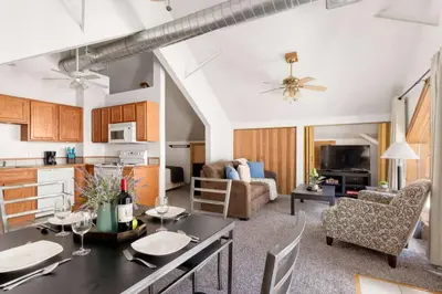 a kitchen and living room with a table and chairs at Studio at St Marys Glacier in Idaho Springs