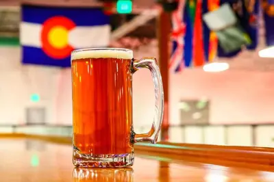 a glass of beer sitting on a table at Studio at St Marys Glacier in Idaho Springs