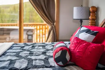 a bedroom with a bed with pillows and a window at Summit Condo at St. Marys in Idaho Springs