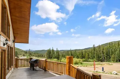 a deck with a view of the mountains at Summit Condo at St. Marys in Idaho Springs