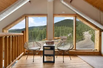 two chairs and a table in a room with a large window at Summit Condo at St. Marys in Idaho Springs