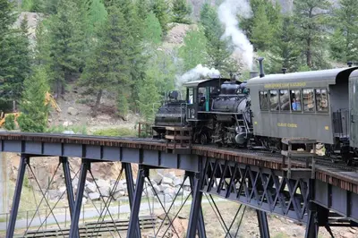 a train on a bridge with people riding on it at Summit Condo at St. Marys in Idaho Springs