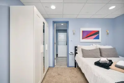 a bedroom with blue walls and a large bed at The Lux in Lakewood. Minutes from Red Rocks. Hikes in Lakewood