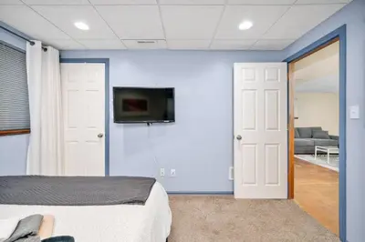 a room with a bed and a tv on a wall at The Lux in Lakewood. Minutes from Red Rocks. Hikes in Lakewood