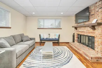 a living room with a couch and a fireplace at The Lux in Lakewood. Minutes from Red Rocks. Hikes in Lakewood