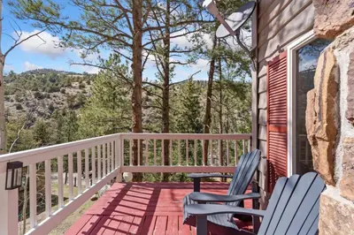 a deck with two chairs on a house at King of the Mountain. Private Hot Tub. Pets allowe in Idaho Springs