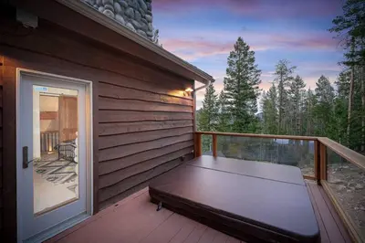 a porch with a bench on the side of a house at Hide-A-Way. Private Hot Tub Pets Welcome. in Evergreen
