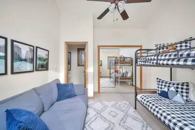 a living room with a couch and a bunk bed at Hide-A-Way. Private Hot Tub Pets Welcome. in Evergreen