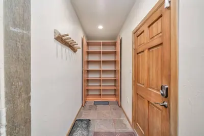 a walk in closet with a wooden door at Hide-A-Way. Private Hot Tub Pets Welcome. in Evergreen