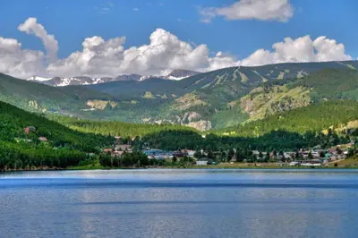 a large body of water with mountains in the background at The Tyrolean Cabin. Panoramic Views. Hot Tub. in Golden