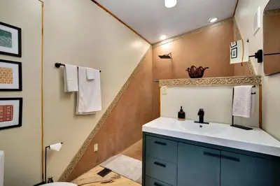 a bathroom with a sink and a toilet at The Tyrolean Cabin. Panoramic Views. Hot Tub. in Golden