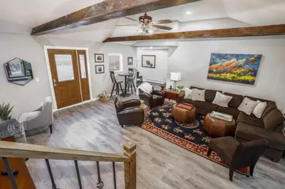 a living room with a couch and a table at Cabin by North Clear Creek. Private Hot Tub. Pets in Black Hawk