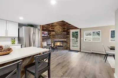 a kitchen and living room with a fireplace at Cabin by North Clear Creek. Private Hot Tub. Pets in Black Hawk