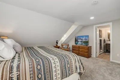 a bedroom with a bed and a dresser with a tv at Cabin by North Clear Creek. Private Hot Tub. Pets in Black Hawk