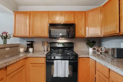 a kitchen with a black stove and a microwave at The Golden Townhouse Walk to downtown Pets Welcome in Golden