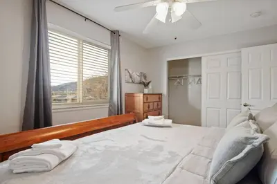 a bedroom with a large bed with towels on it at The Golden Townhouse Walk to downtown Pets Welcome in Golden