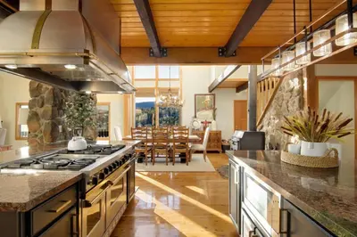 a kitchen with a stove and a dining room at New. Top of the World Lodge. Hot tub. Theater. in Evergreen