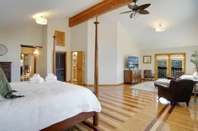 a bedroom with a large bed and a living room at New. Top of the World Lodge. Hot tub. Theater. in Evergreen
