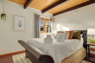 a bedroom with a large bed and a window at New. Top of the World Lodge. Hot tub. Theater. in Evergreen