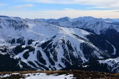 a snow covered mountain range with trees and mountains at New Classic Comfortable Rino Escape. Pets Welcome in Denver