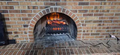 a brick oven with a fire in it at Tiki Bar in The Basement in Arvada