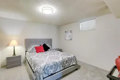 a bedroom with a bed and a lamp at Stress-Free Commuting! Extended Stay in Littleton in Littleton