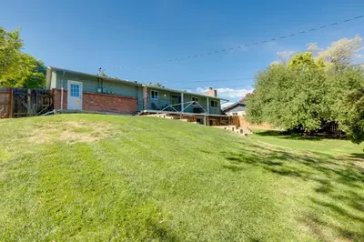 a house on top of a grassy hill at Stress-Free Commuting! Extended Stay in Littleton in Littleton