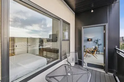 a bedroom with a bed and a balcony with a view at The Espadin LoHi Collection in Denver