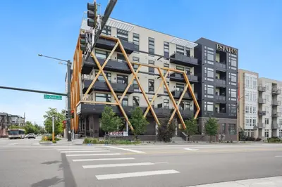 a building on a street corner with a large building at The Espadin LoHi Collection in Denver