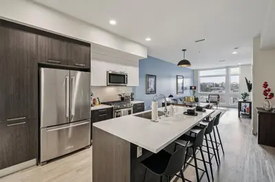 a kitchen with a large island with a counter top at The Espadin LoHi Collection in Denver