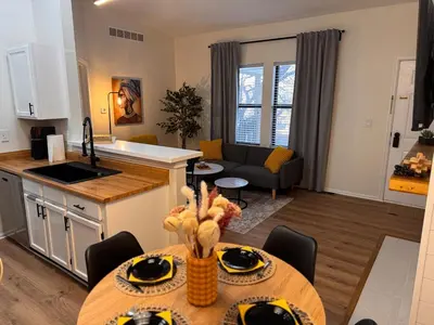 a kitchen and a living room with a table in a room at Beautifully Renovated OneBedroom Apt with Two Beds in Littleton